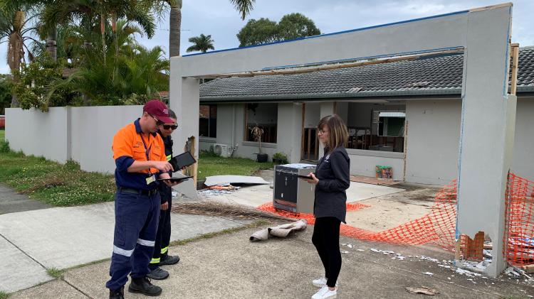 DARM recovery officers inspect a flood-damaged property in Brisbane, Queensland.