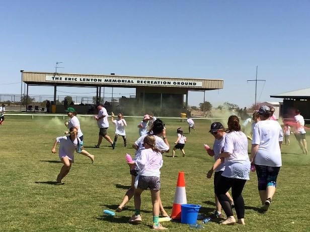 Participants running in the colour battle