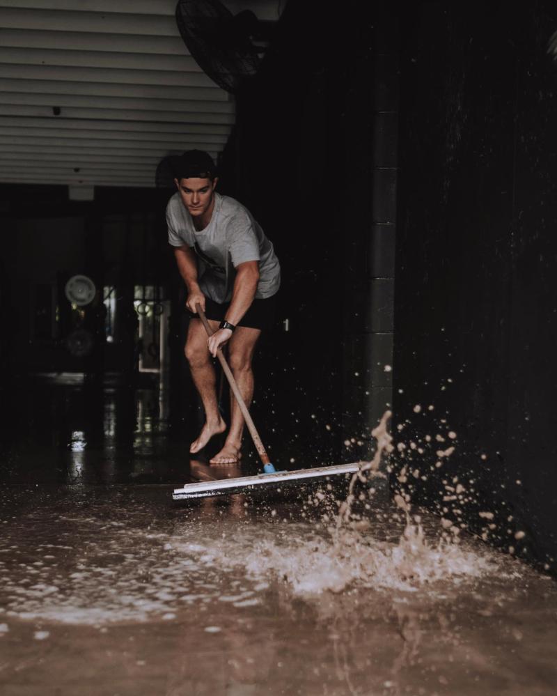 Pushing water with broom