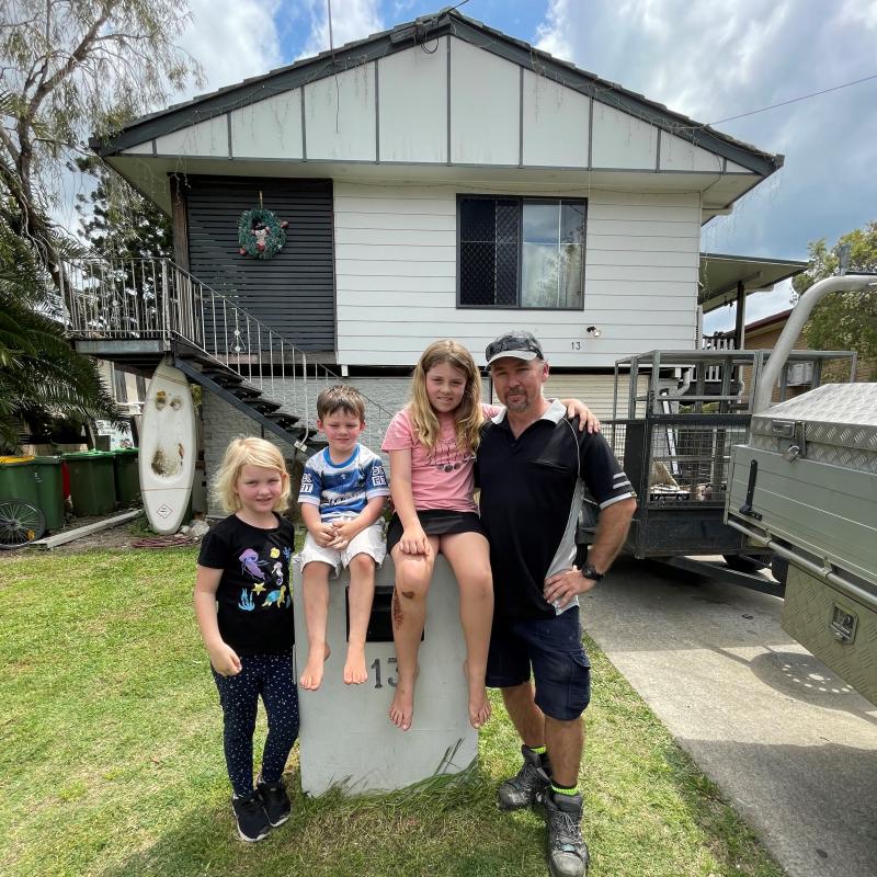 Dirk de Vos with family in front of his Goodna home.