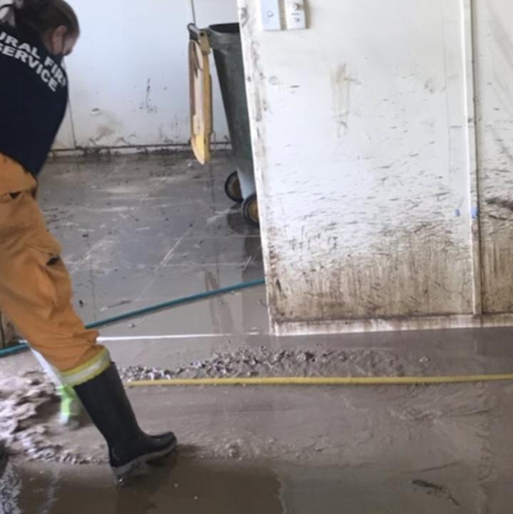 Removing mud from inside Chris and Ronnella Onyeajum's house.