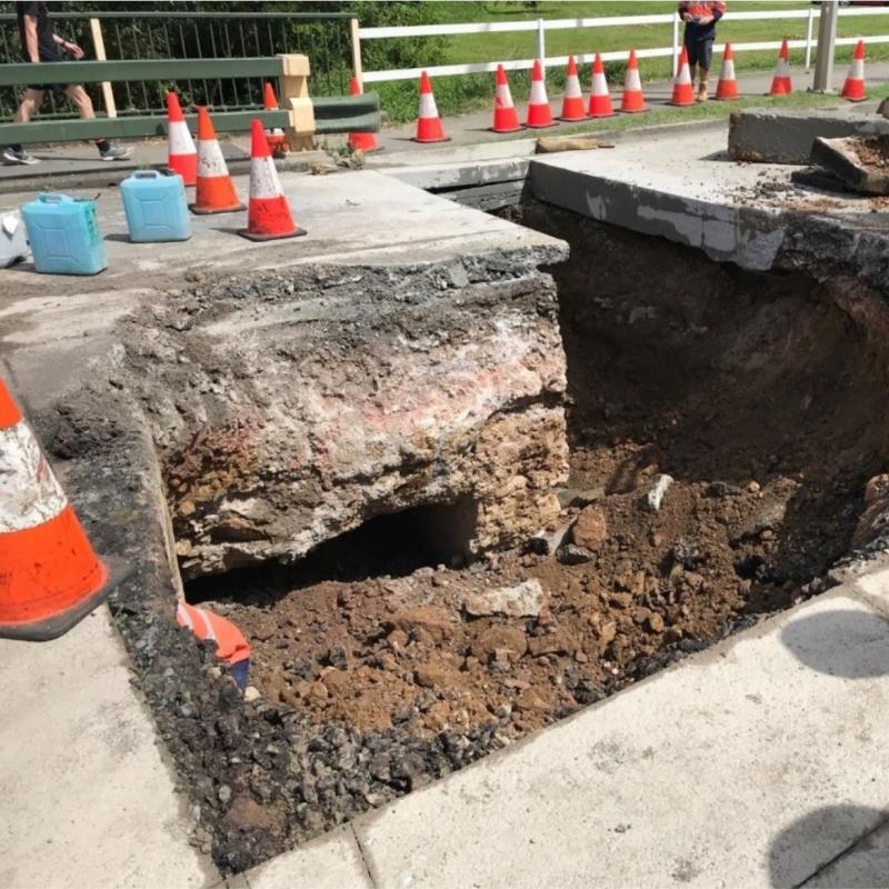 Severe erosion on Gympie Arterial Road over Downfall Creek at Chermside, Brisbane.