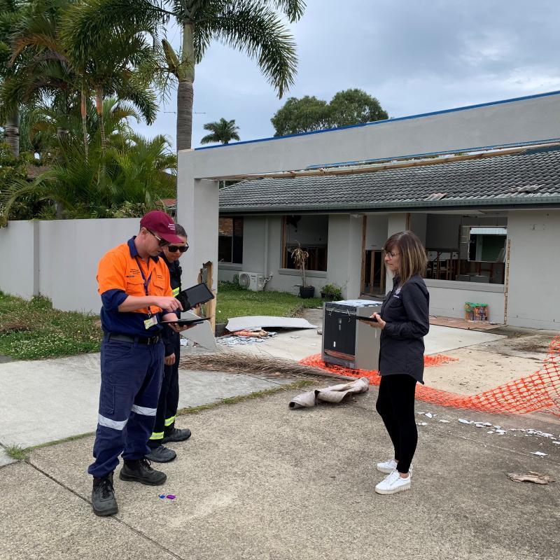 DARM recovery officers inspect a flood-damaged property in Brisbane, Queensland.