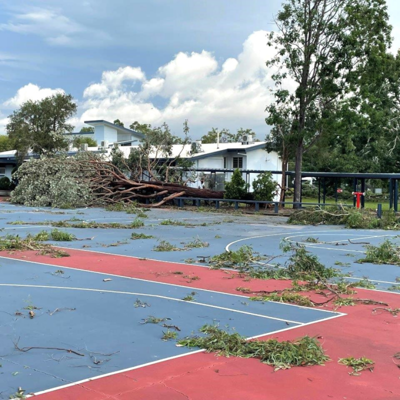 Tree debris strewn across the basketball courts at Woodridge State High School following a wild tornado in February 2022.
