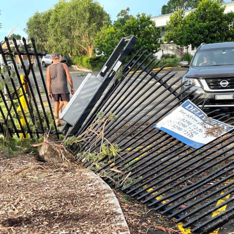 Falling trees damaged other structures, such as this fence, when a tornado tore through Woodridge State High School in February 2022.
