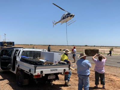 Helicopter dropping fodder in outback