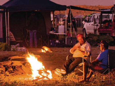People sitting by camp fire