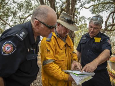 Rural fire brigade team looking at plans