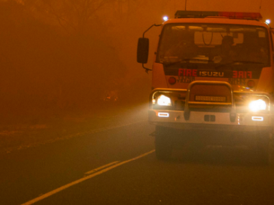 Fire truck driving through smoky conditions