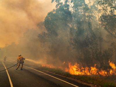 Firefighter hosing fire